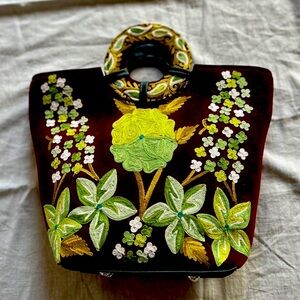 It’s a velvet purse with hand work called chain stitch and aari embroidery.